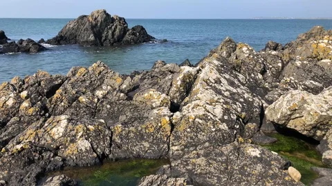 Waves breaking onto rockpools Stock Footage 106002308
