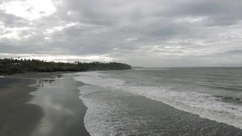 Waves breaking on the rocks on Bali Island Beach 4K Drone flight Stock-Footage 119319242