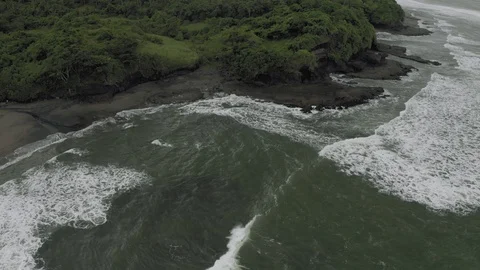 Waves breaking on the rocks on Bali Island Beach 4K Drone flight Видео 119319390