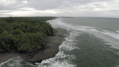 Waves breaking on the rocks on Bali Island Beach 4K Drone flight Stock Footage 119319566