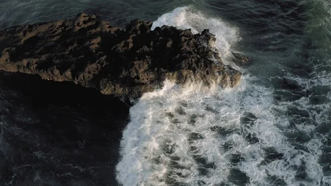 Waves breaking on the rocks Batu Balong beach Bali Island 4K Drone flight Stock-Footage 119290754