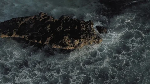 Waves breaking on the rocks Batu Balong beach Bali Island 4K Drone flight Stock Footage 119290887