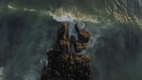 Waves breaking on the rocks Batu Balong beach Bali Island 4K Drone flight Stock Footage 119291106