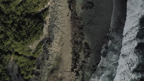 Waves breaking on the rocks Batu Balong beach Bali Island 4K Drone flight Vídeo Stock 119337837