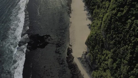 Waves breaking on the rocks Batu Balong beach Bali Island 4K Drone flight Видео 119338262