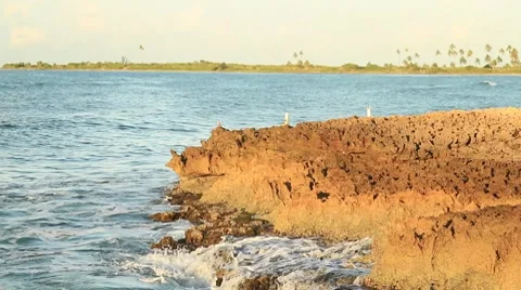 Waves breaking in rocks on the beach Stock Footage 8761742