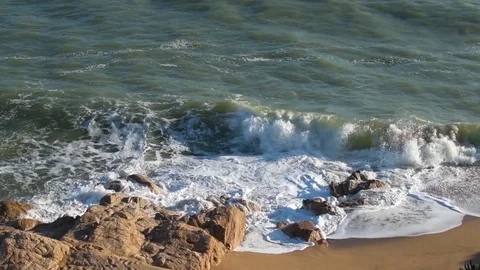 Waves breaking on the rocks at the beach Stock Footage