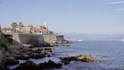 Waves breaking on the rocks below the ramparts of Antibes Stock Footage 346286998