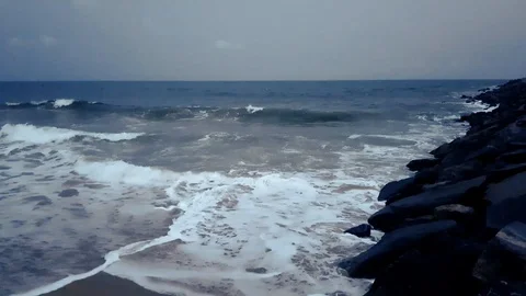 Waves breaking on rocks in a breakwater. Twilight at the beach. Stock Footage 105821611