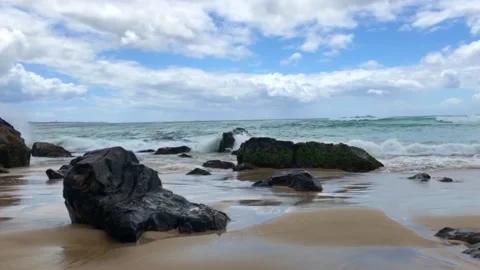 Waves breaking on the rocks in Byron Bay Beach in Australia Stock Footage 138612986