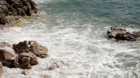 Waves breaking the rocks. Close up. Clean water. Stock Footage 53808999
