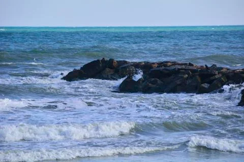 Waves breaking on the rocks of the coast. Stock Photos