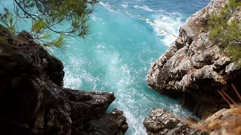 Waves breaking on rocks Stock Footage 79024653