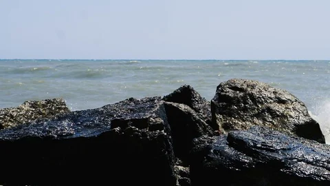 Waves breaking on rocks. Italy. Slow motion. Stock Footage 99402923
