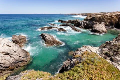 Waves breaking on the rocks. Stock Photos