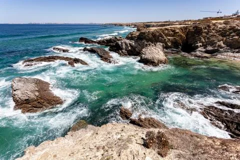 Waves breaking on the rocks. Stock Photos