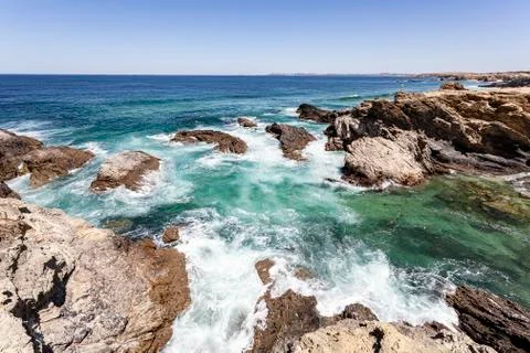 Waves breaking on the rocks. Stock Photos