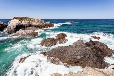 Waves breaking on the rocks. Stock Photos