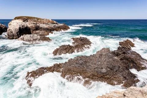 Waves breaking on the rocks. Stock Photos