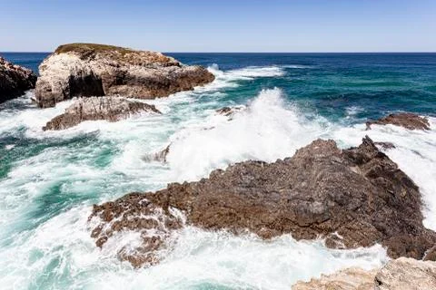 Waves breaking on the rocks. Stock Photos