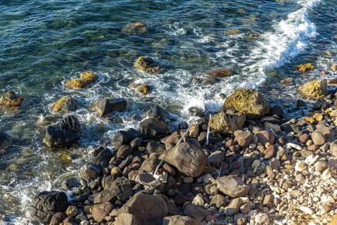 Waves breaking on rocks Stock Photos