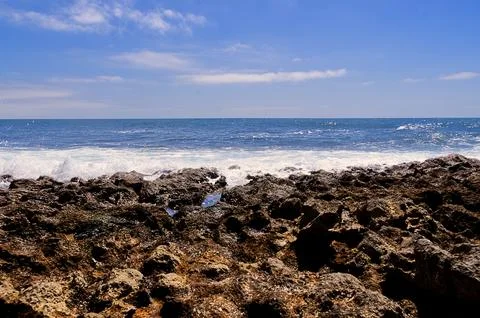Waves breaking on the rocks Stock Photos