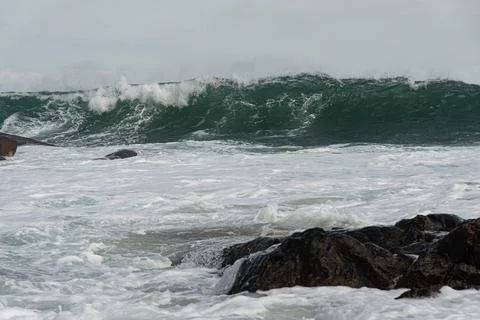Waves breaking on the rocks Stock Photos