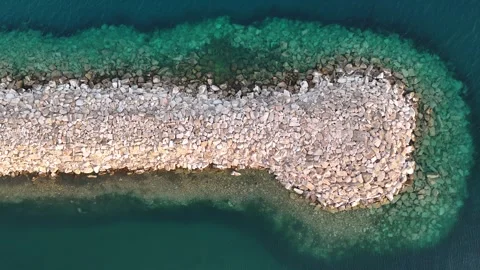 Waves breaking on the rocks of the pier. Concrete blocks in the sea Video stock 278793799