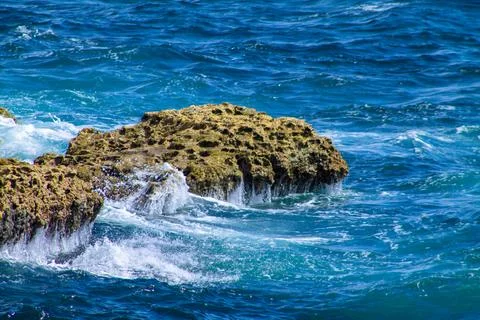 Waves breaking on the rocks in the Shete Boka National Park, Curaao Stock Photos