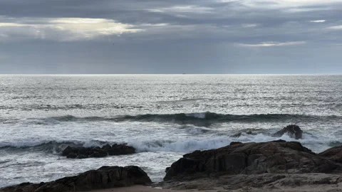 Waves breaking at rocks sunset beach at Leça da Palmeira Portugal 動画素材 209301852