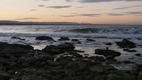 Waves breaking on rocks at sunset Stock Footage 168311357