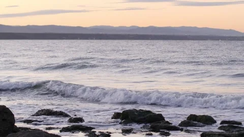 Waves breaking on rocks on sunset Stock Footage 168311363