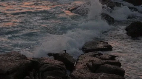 Waves breaking on the rocks at sunset Stock Footage 337543029