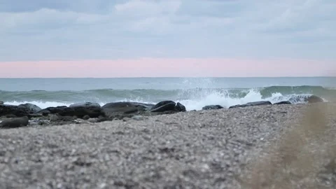 Waves breaking on rocks on sunset in slow motion Stock Footage 168310888