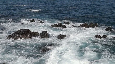 Waves breaking on rocky beach Stock Footage 70694332
