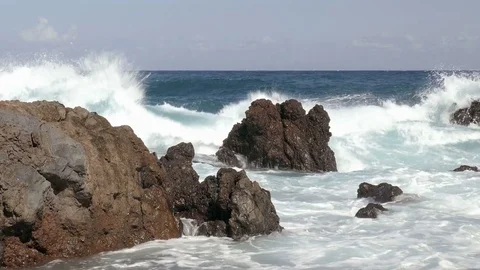 Waves breaking on rocky coastline Stock Footage 70695958