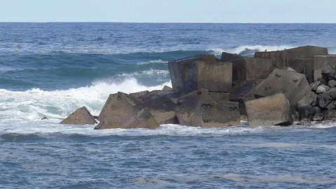 Waves breaking on rocky coastline Stock Footage 72771396