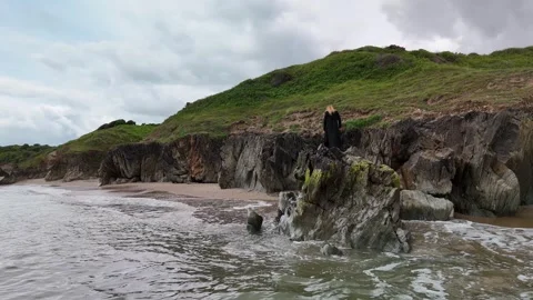 Waves Breaking on Rocky Coastline with Grassy Cliffs 4K Видео 337846965