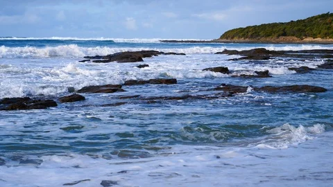 Waves breaking on rocky shore Stock Footage 92449485