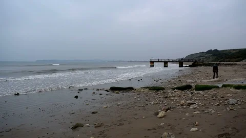 Waves breaking onto sand at Bowleaze Cove Stock Footage 106093069