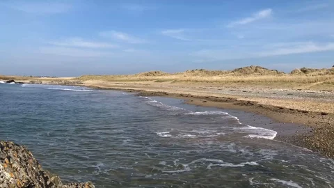 Waves breaking onto a sandy beach Stock Footage 106002288