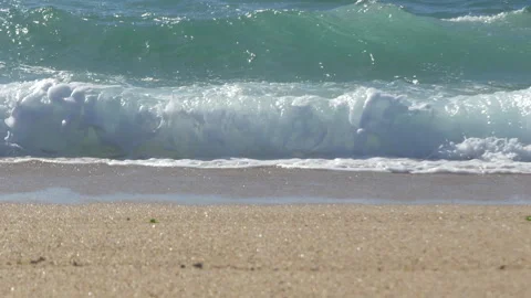 Waves breaking on sandy beach. Low angle Stock Footage 273657146