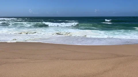 Waves breaking on sandy beach in Portugal in Spring. Slow motion. Panning shot. Stock Footage 239201251