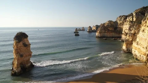 Waves breaking on sandy ocean beach Praia Dona Ana with famous beautiful coastal 스톡 동영상 89541809