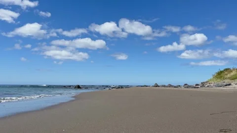Waves breaking on sandy shore of empty beach in summer Stock Footage 272578288