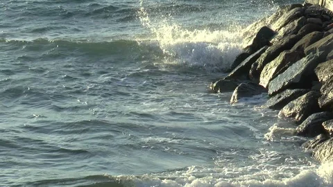Waves breaking on a Sea Defence Stock Footage 120460980