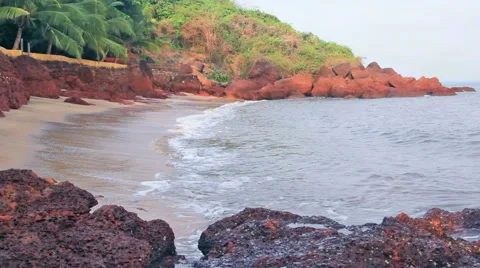 Waves Breaking in Secluded Beach Stockbeeldmateriaal 54766415