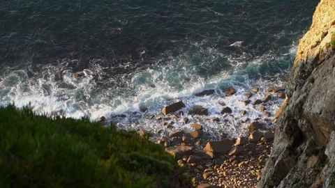 Waves breaking on the shore of tiny rocky inaccessible beach Stock Footage 110761303