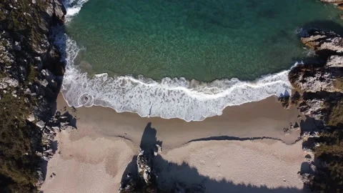 Waves breaking on the shore from the view of a drone. Stock Footage 239225915
