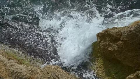 Waves breaking on the shore. Waves crashing into rocks on the sea Stock Footage 308235519